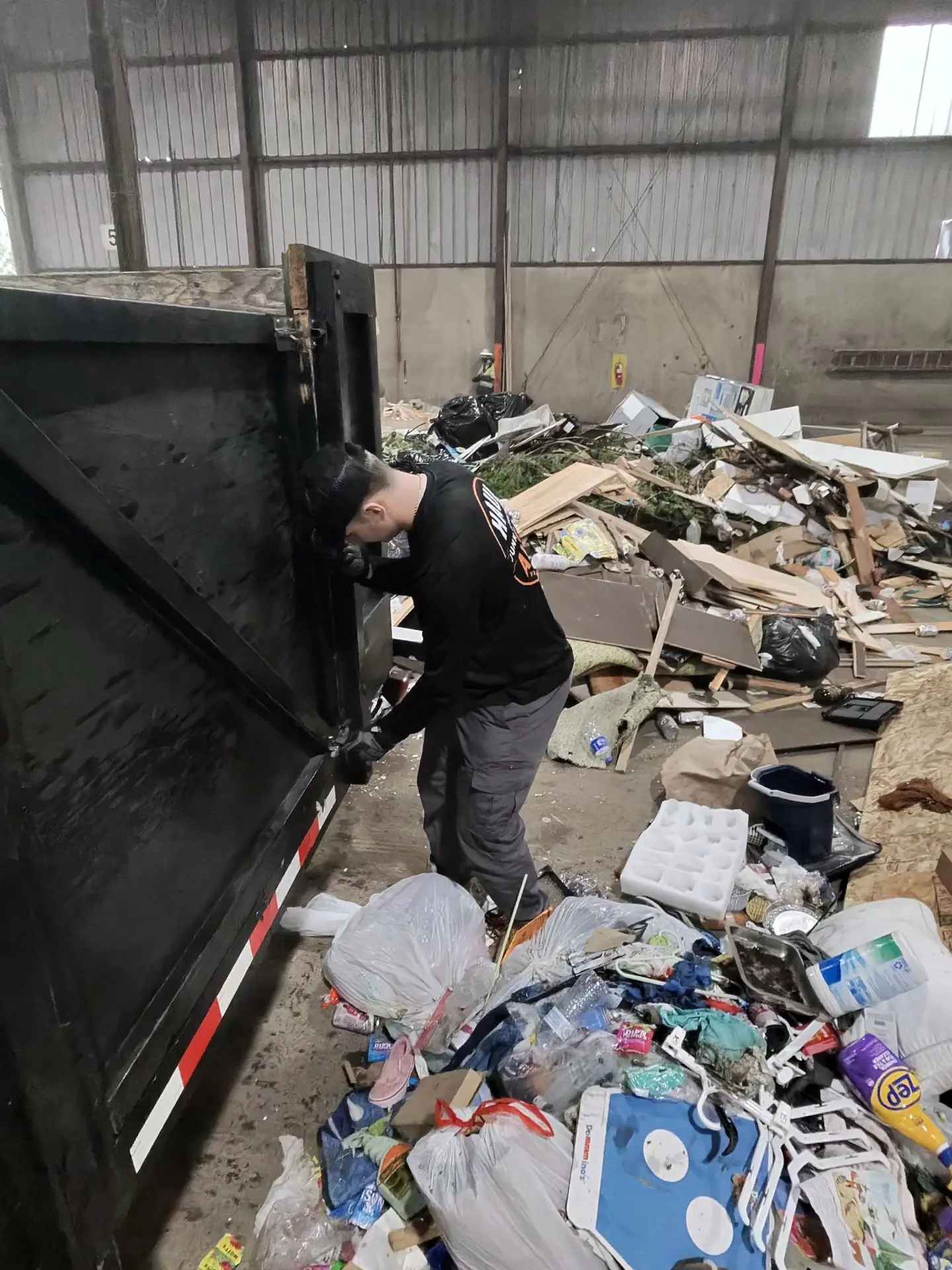 Haul Away crew member responsibly unloading junk at the transfer station